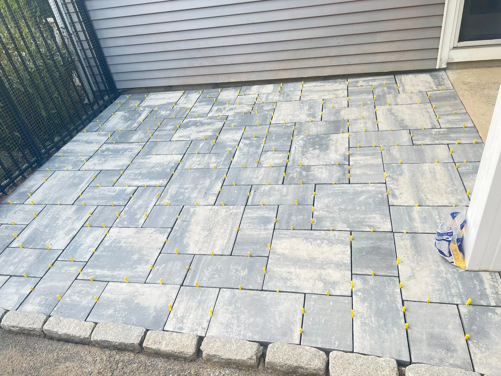 Large-format paver patio installation in progress
